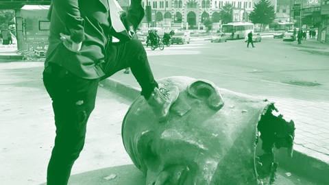 stepping on assaad statue