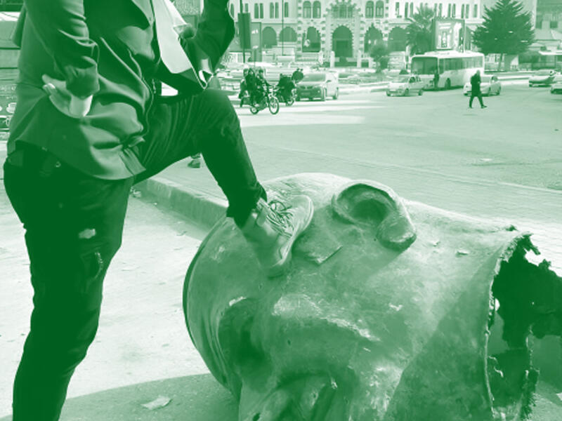 stepping on assaad statue