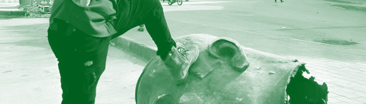 stepping on assaad statue