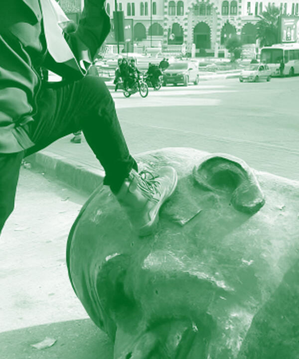 stepping on assaad statue